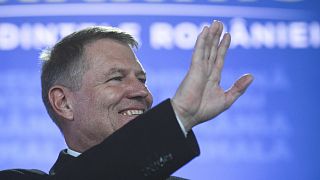 Incumbent candidate Klaus Iohannis reacts after receiving the first exit poll results following the second round of a presidential election in Bucharest, Romania