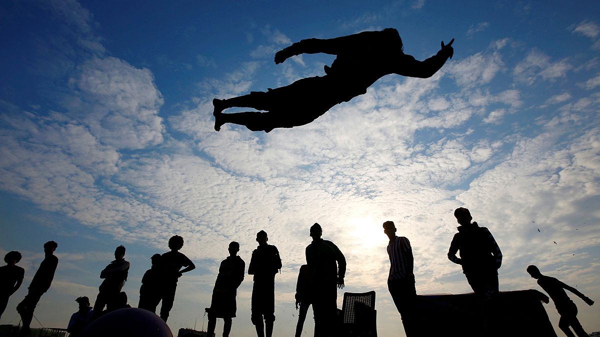 Iraqi demonstrators perform a somersault as they practice parkour during ongoing anti-government protests, near the Tigris River in Baghdad, Iraq. December 9, 2019.     