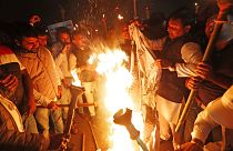 Members of the youth wing of India's main opposition Congress party burn a copy of Citizenship Amendment Bill