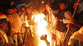 Members of the youth wing of India's main opposition Congress party burn a copy of Citizenship Amendment Bill