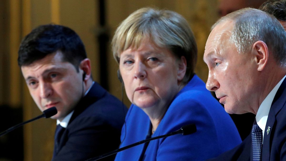Ukraine's Volodymyr Zelenskiy, Germany's Angela Merkel and Russia's Vladimir Putin attend a joint news conference after summit in Paris on December 10, 2019.