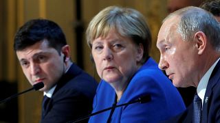 Ukraine's Volodymyr Zelenskiy, Germany's Angela Merkel and Russia's Vladimir Putin attend a joint news conference after summit in Paris on December 10, 2019.