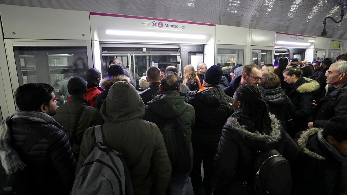 Commuters wait to board a train at the Gare du Nord metro station in Paris 