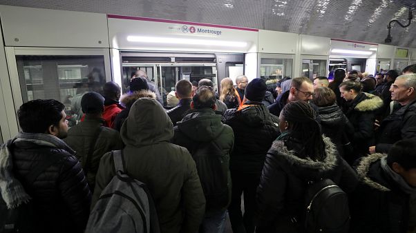 Commuters wait to board a train at the Gare du Nord metro station in Paris Commuters wait to board a train at the Gare du Nord metro station in Paris