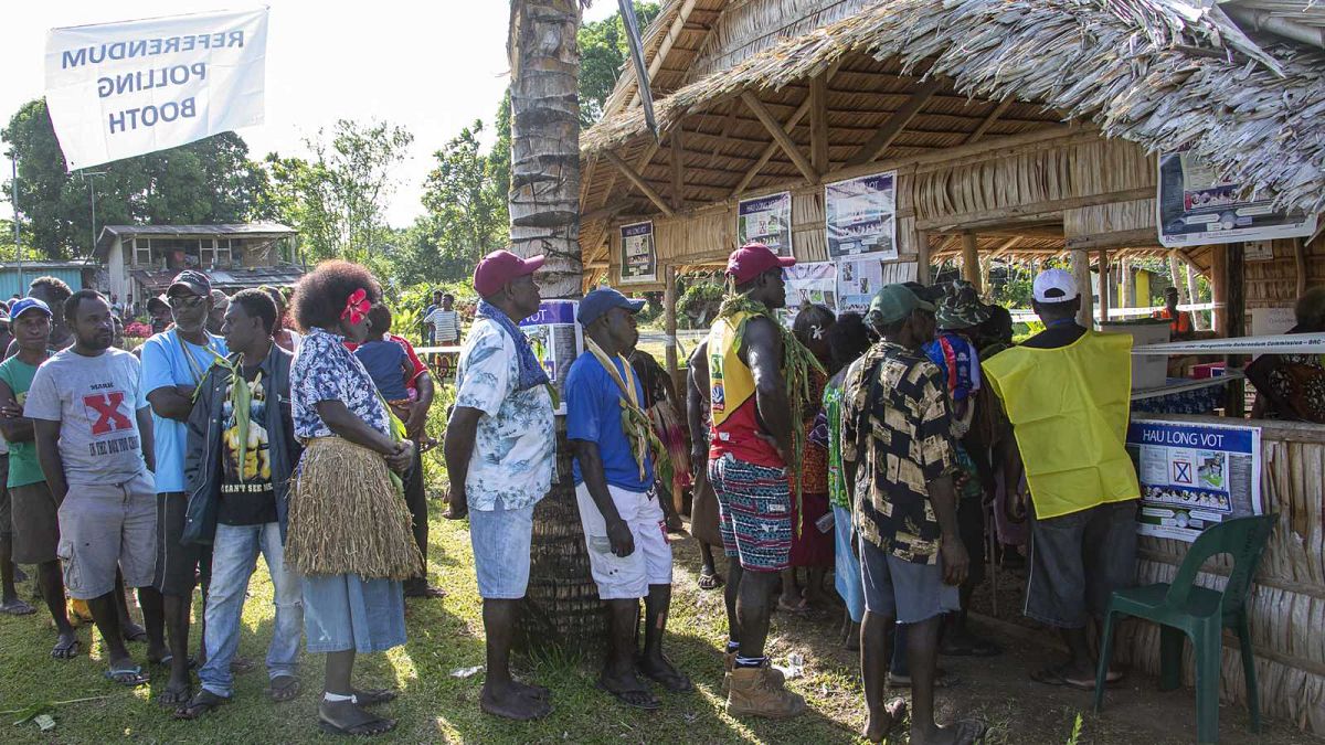 People queue to vote at a polling station in the capital Buka in an historical independence vote on November 25, 2019. 