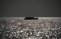 An overcrowded rubber boat is seen on the horizon in the Mediterranean Sea, 18 September, 2019. The Ocean Viking regularly conducts rescue missions on the Mediterranean,
