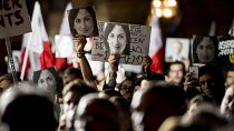 Protestors hold photos of Daphne Caruana Galizia during a 2019 demonstration in Valletta.