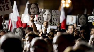 Protestors hold photos of Daphne Caruana Galizia during a 2019 demonstration in Valletta.