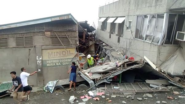 Rescue crew members look for trapped victims at collapsed building at Padada market, in Padada Philippines December 15, 2019 Rescue crew members look for trapped victims at collapsed building at Padada market, in Padada Philippines December 15, 2019