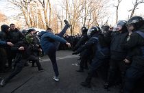 Activists of Ukrainian far-right movements clash with police forces during a protest against land sale reform in front of the Parliament in Kiev on December 17, 2019.