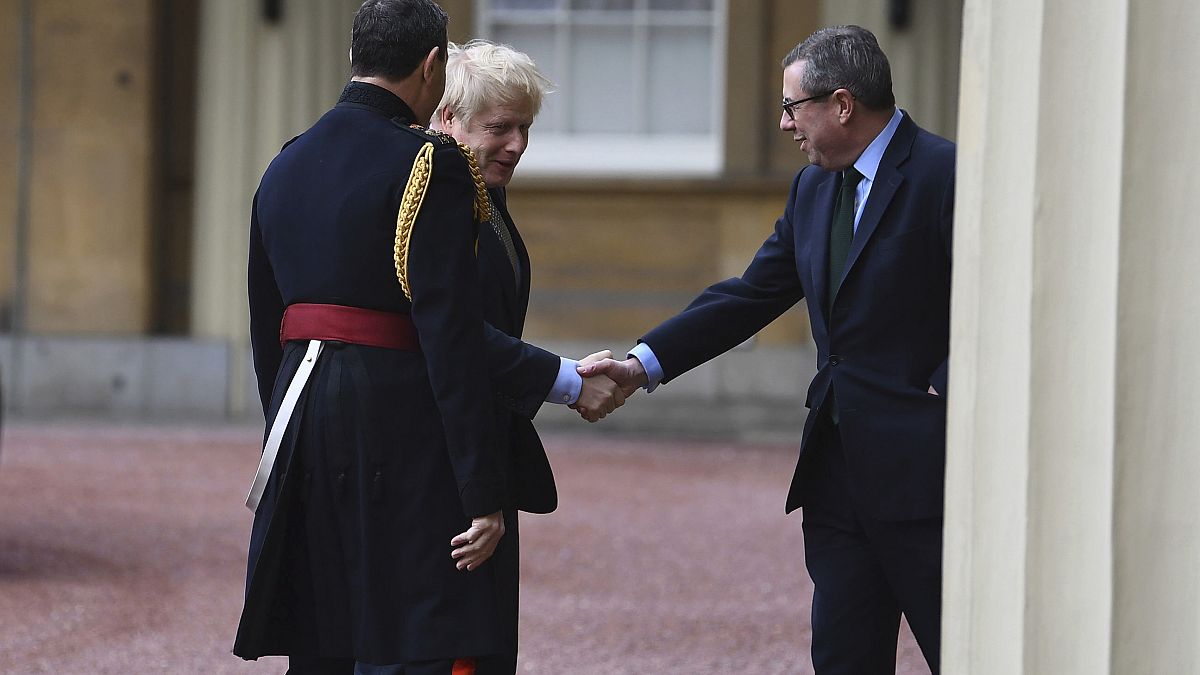 Prime Minister Boris Johnson is greeted by the Queen's Equerry-in-Waiting Lieutenant Colonel Charles Richards (left) and her private secretary Edward Young.  