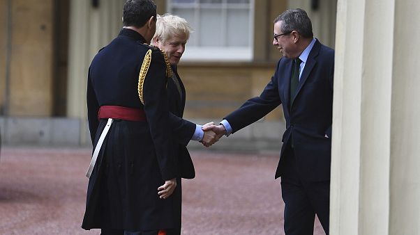 Prime Minister Boris Johnson is greeted by the Queen's Equerry-in-Waiting Lieutenant Colonel Charles Richards (left) and her private secretary Edward Young. Prime Minister Boris Johnson is greeted by the Queen's Equerry-in-Waiting Lieutenant Colonel Charles Richards (left) and her private secretary Edward Young.