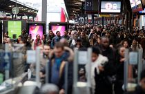Commuters walk on a platform at Gare de l'Est train station during a strike by all unions of French SNCF and the Paris transport network (RATP) in Paris 