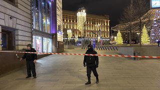 Russian police officers secure the area near the building of the Federal Security Service (FSB, Soviet KGB successor) in the background in Moscow, Russia, Thursday, Dec. 19