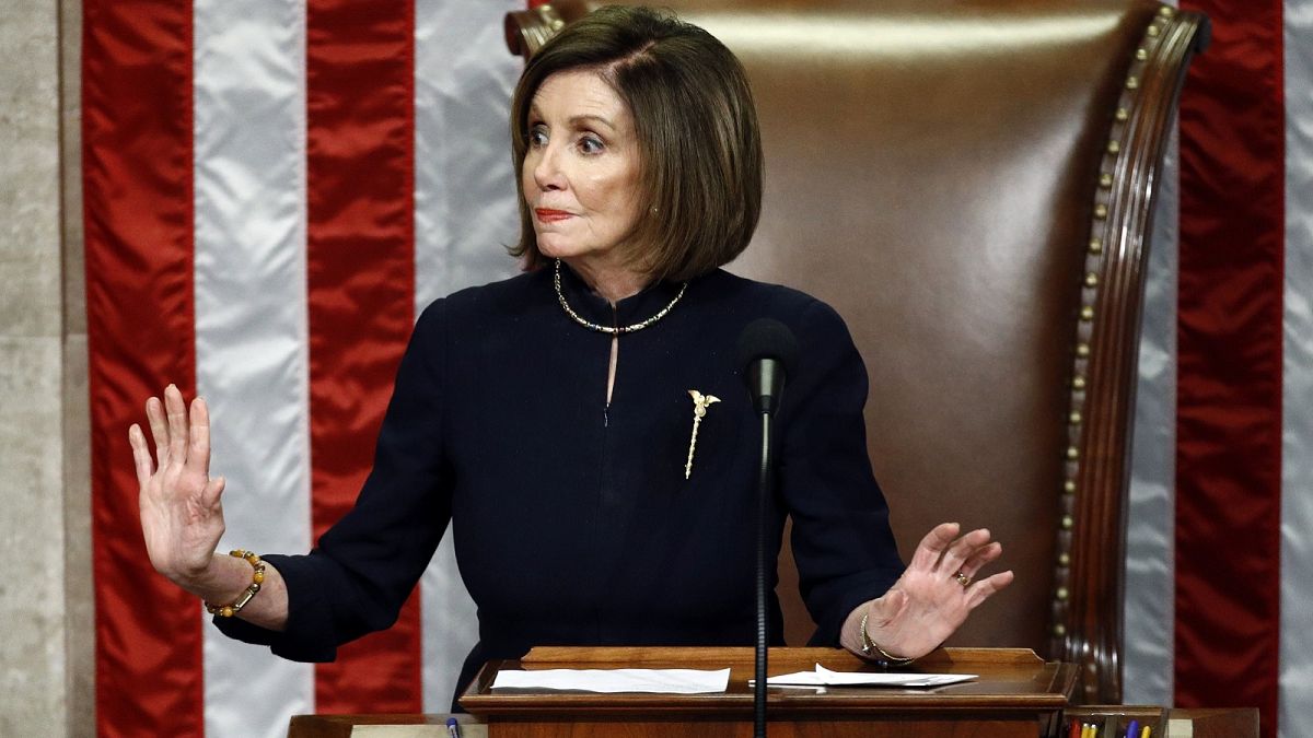 House Speaker Nancy Pelosi of Calif., gestures for Democrats to stop talking during a vote on the articles of impeachment against President Donald Trump, Dec. 18, 2019