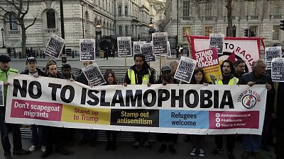 People hold up a banner during a 'Unity Vigil' against racism and Islamophobia in reaction to Wednesday's attack, backdropped by the gates of Downing Street in London People hold up a banner during a 'Unity Vigil' against racism and Islamophobia in reaction to Wednesday's attack, backdropped by the gates of Downing Street in London