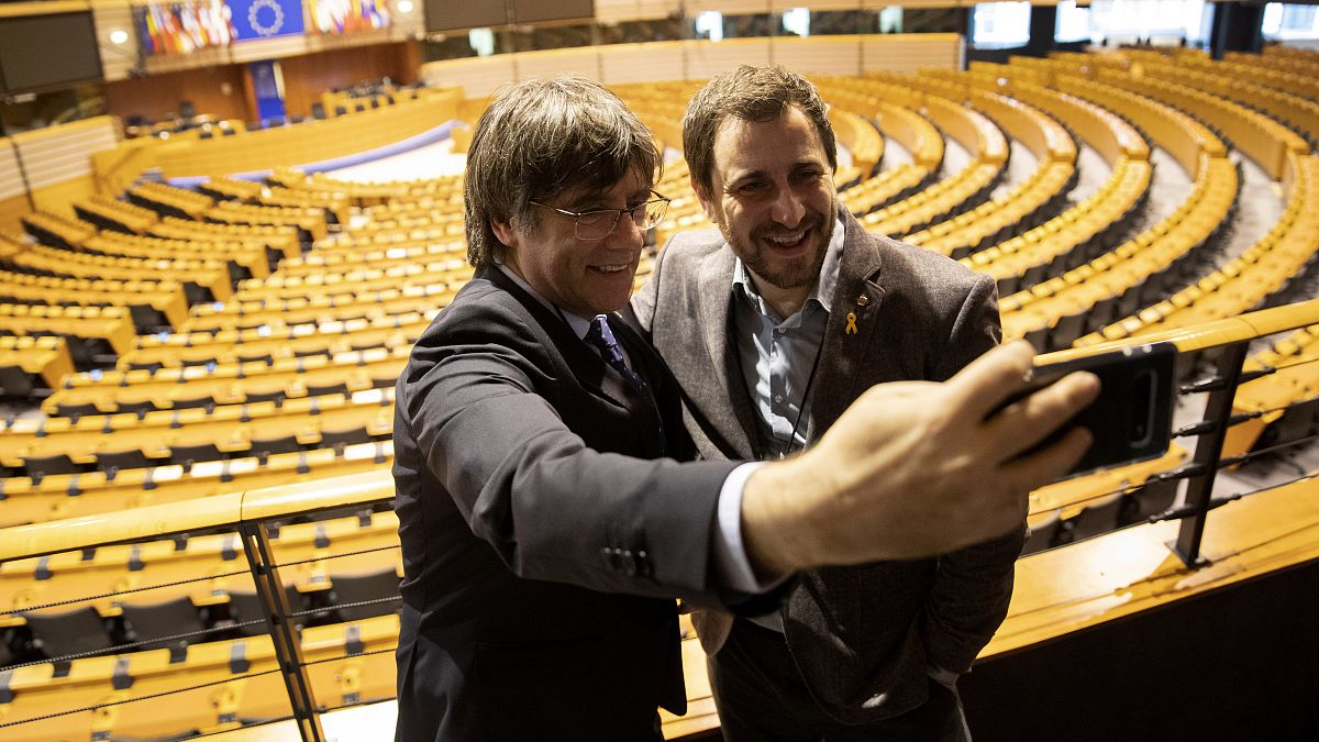 Carles Puigdemont, left, and former Catalan regional minister Antoni Comin take a selfie overlooking the plenary chamber at the European Parliament.