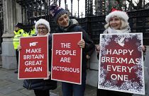Pro Brexit demonstrators hold banners outside Parliament in London, Friday, Dec. 20, 2019. 