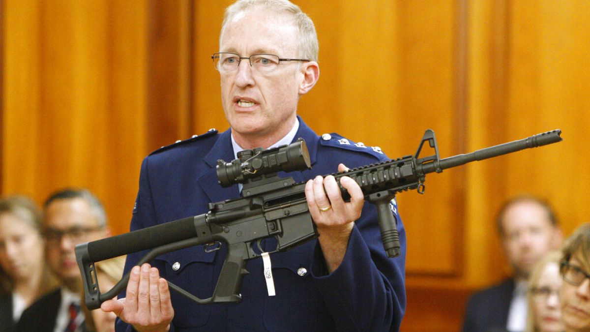 Police chief Mike McIlraith shows New Zealand MPs an AR-15 style rifle similar to one of the weapons a gunman used to kill 51 worshippers at two New Zealand mosques