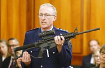 Police chief Mike McIlraith shows New Zealand MPs an AR-15 style rifle similar to one of the weapons a gunman used to kill 51 worshippers at two New Zealand mosques