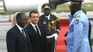 French President Emmanuel Macron is welcomed by President Alassane Ouattara upon arrival in Abidjan, Ivory Coast, Friday dec. 20, 2019 for a three-days official visit. 