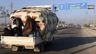 A family flees toward Turkey from Idlib as Syrian government forces shell the region