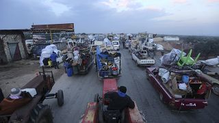 Truckloads of civilians on the main road near Hazano, Syria fleeing a Syrian military offensive