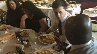 Democratic presidential candidate Pete Buttigieg listens to Mikey Kelly as the South Bend mayor meets with black voters at a soul food restaurant in North Las Vegas