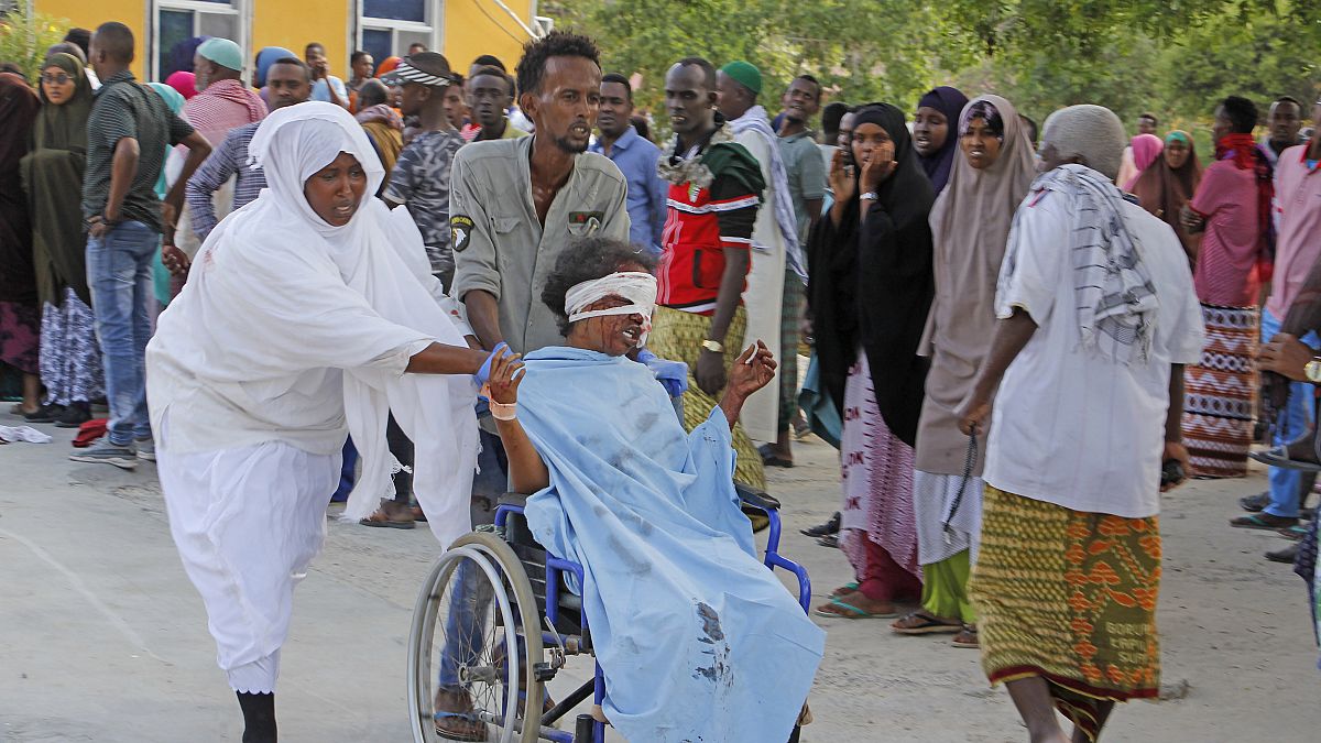  A civilian who was wounded in the Mogadishu suicide car bomb attack is helped