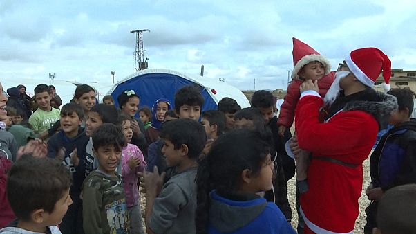 Ativistas distribuem presentes em campo de refugiados sírio Ativistas distribuem presentes em campo de refugiados sírio