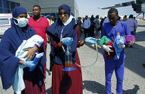 Medical personnel carry wounded children to be airlifted to the Turkish capital for treatment after they were injured in Saturday's car bomb blast in Mogadishu, Somalia.