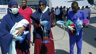 Medical personnel carry wounded children to be airlifted to the Turkish capital for treatment after they were injured in Saturday's car bomb blast in Mogadishu, Somalia. 