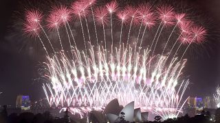 In this Sunday, Jan. 1, 2017 photo, fireworks explode over the Sydney Opera House and Harbour Bridge as New Year's celebrations are underway in Sydne. (AP Photo/Rick Rycroft, 