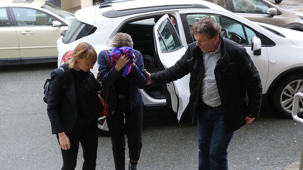 A British woman, accused of lying about being gang raped, covers her face as she arrives at the Famagusta courthouse in Paralimni. A British woman, accused of lying about being gang raped, covers her face as she arrives at the Famagusta courthouse in Paralimni.