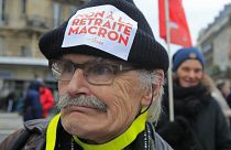 A demonstrators wears a sticker on his hat that reads, "no to Macron's pension reform during a protest in Paris, Saturday, Dec. 28, 2019. 