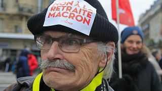 A demonstrators wears a sticker on his hat that reads, "no to Macron's pension reform during a protest in Paris, Saturday, Dec. 28, 2019. 