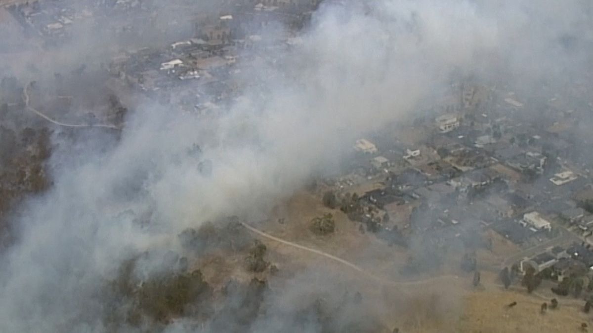 Australian firefighters battle bushfires in suburban Melbourne
