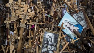 In this photo taken on Wednesday, July 17, 2019, crosses, rosaries and portraits of the Virgin Mary are displayed, at the Hill of Crosses a Lithuanian national pilgrimage site