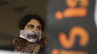 Protesters stage a demonstration outside a court house in support of a 19 year-old British woman who was found guilty of fabricating claims that she was gang raped. 