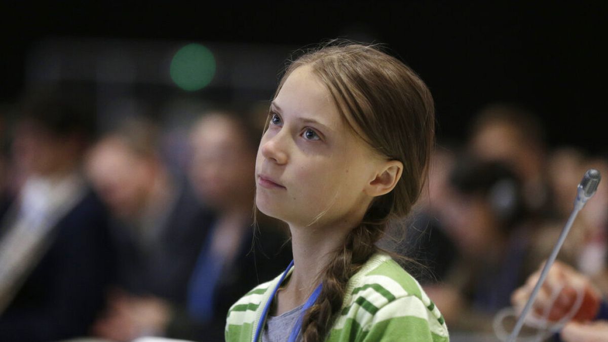 Swedish climate activist Greta Thunberg listens to speeches before addressing a plenary of UN climate conference at the COP25 summit in Madrid, Spain
