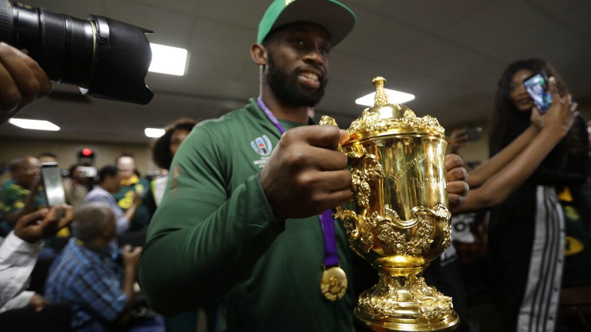 South African Springbok rugby captain Siya Kolisi with the Web Ellis trophy arrives back on home soil at the O.R. Tambo Airport in Johannesburg Tuesday, Nov. 5, 2019. 