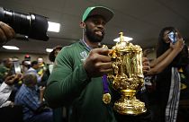 South African Springbok rugby captain Siya Kolisi with the Web Ellis trophy arrives back on home soil at the O.R. Tambo Airport in Johannesburg Tuesday, Nov. 5, 2019.