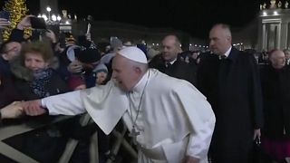 The pope fights to get away from a woman outside the Vatican.