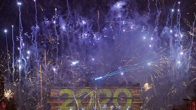 Fireworks set to mark the New Year explode over the Arc de Triomphe on the Champs Elysees,