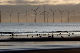 An offshore wind farm is visible from the beach in Hartlepool, England, Tuesday, Nov. 12, 2019.
