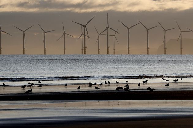 An offshore wind farm is visible from the beach in Hartlepool, England, Tuesday, Nov. 12, 2019. 