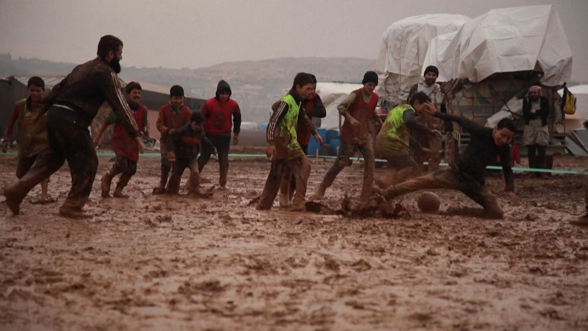 Displaced Syrians enjoy a game of football in jihadist-run region