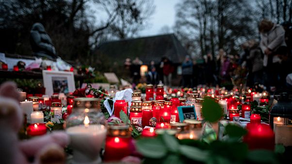 Flowers and candles left at a makeshift memorial site in front of the burned-out monkey house at Krefeld Zoo Flowers and candles left at a makeshift memorial site in front of the burned-out monkey house at Krefeld Zoo