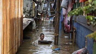 A man swims in flood water in a low-income neighborhood in Jakarta, Indonesia. 2 January 2020. 