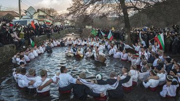 Bulgarians sing, play bagpipes and chaindance in the icy waters during Epiphany ritualin